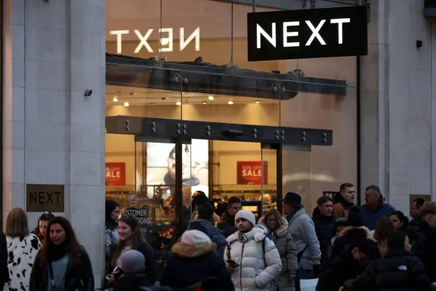 FILE PHOTO: Shoppers walk past a NEXT retail store on Oxford Street in London, Britain, December 28, 2025. REUTERS/Isabel Infante/File Photo