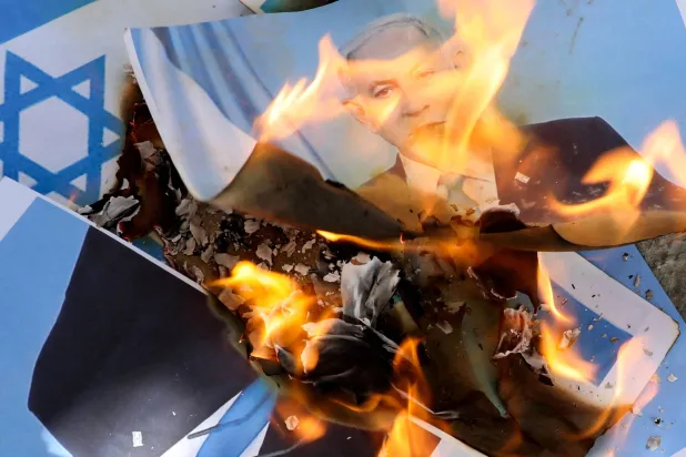 Somalis burn the Israel flag and an image depicting Israeli Prime Minister Benjamin Netanyahu during a demonstration, after Israel became the first country to formally recognize the self-declared Republic of Somaliland, at the Mogadishu Stadium in Warta Nabada district of Mogadishu, Somalia December 30, 2025. (Reuters)