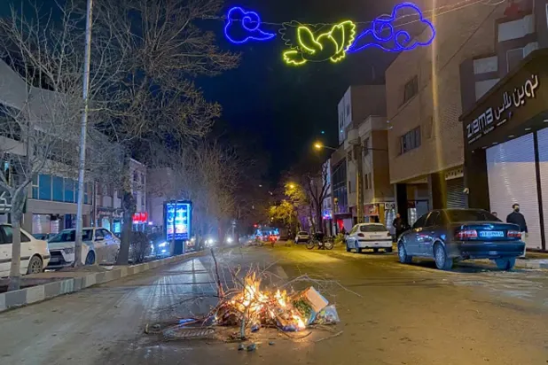 Burning debris lies in the middle of a street during protests in Hamedan, western Iran, Jan. 1, 2026. (AFP/Getty Images) 