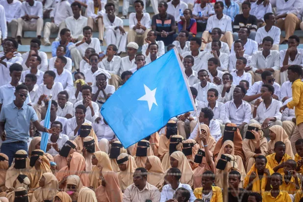 Residents wave Somali flags as they attend a rally denouncing Israel's recent announcement recognizing the breakaway Somaliland region, during a gathering calling for Somalia's territorial unity at Mogadishu Stadium in Mogadishu on December 30, 2025. (AFP)
