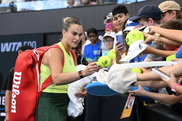 Aryna Sabalenka (L) of Belarus signs autographs for fans after the quarter-finals of the Brisbane International tennis tournament at Pat Rafter Arena in Brisbane, Australia, 09 January 2026. (EPA)