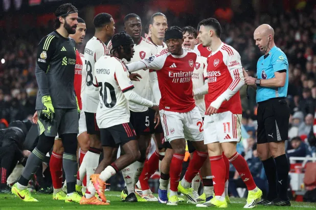 Noni Madueke (C) of Arsenal pushes back Jeremie Frimpong of Liverpool who is approaching Gabriel Martinelli (R) of Arsenal during the English Premier League match between Arsenal FC and Liverpool FC, in London, Britain, 08 January 2026. (EPA)