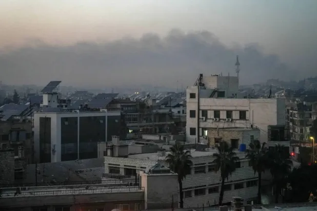 Thick smoke rises from areas of fighting between the Syrian army and the SDF in Aleppo (EPA) 