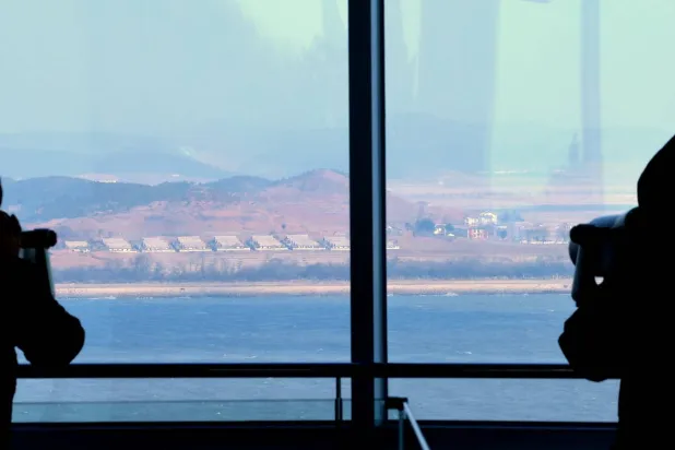 Visitors look at North Korea's border county of Kaepung through tower viewers at South Korea's Ganghwa Peace Observatory in the western county of Ganghwa; 10 January 2026. (EPA/Yonhap)