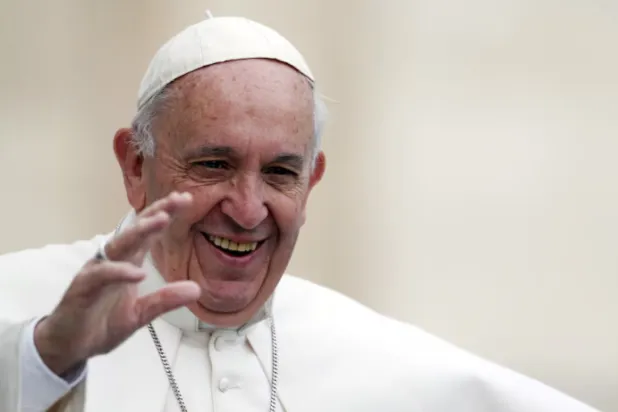 Pope Francis waves as he arrives to lead the weekly audience in Saint Peter's Square at the Vatican, October 21, 2015. REUTERS/Alessandro Bianchi/File Photo 