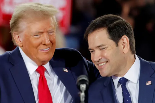 Republican presidential nominee and former US President Donald Trump and Senator Marco Rubio (R-FL) react during campaign event at Dorton Arena, in Raleigh, North Carolina, US November 4, 2024. REUTERS/Jonathan Drake/