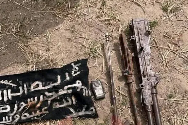 سلاح وعلم كانا بحوزة إرهابي قُتل على يد الجيش النيجيري (تواصل اجتماعي)