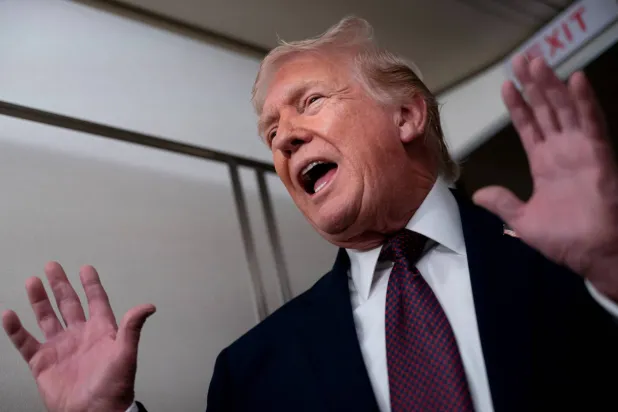 US President Donald Trump speaks with members of the media aboard Air Force One en route from Florida to Joint Base Andrews, Maryland, US, January 11, 2026. REUTERS/Nathan Howard