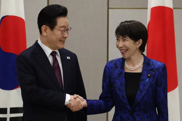 13 January 2026, Japan, Nara: Japan's Prime Minister Sanae Takaichi shakes hands with South Korea's President Lee Jae Myung at the start of their summit meeting in Nara. (dpa)