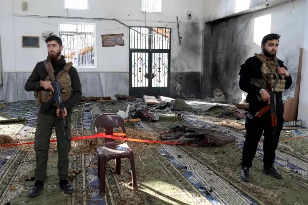 Security personnel inside the Imam Ali bin Abi Talib Mosque in the Wadi al-Dhahab neighborhood of Homs following a bombing . (AFP)