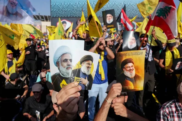 Supporters of Hezbollah hold portraits of its general secretaries on the first anniversary of the assassination of Hassan Nasrallah. (Reuters file)