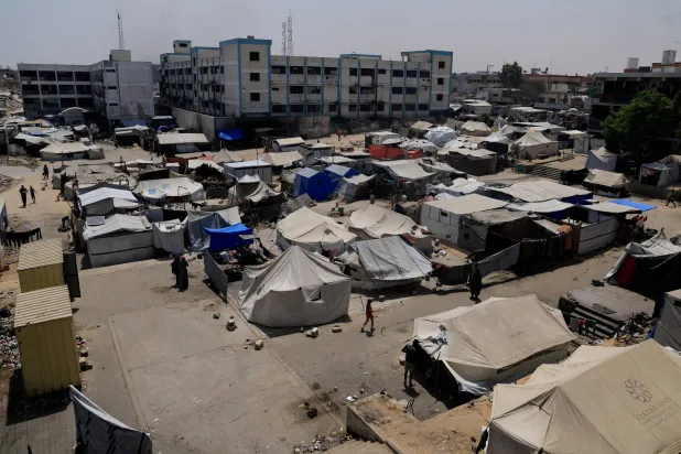 Palestinians displaced by the Israeli military offensive shelter in an UNRWA school, in Khan Younis, in the southern Gaza Strip, August 19, 2025. (Reuters)