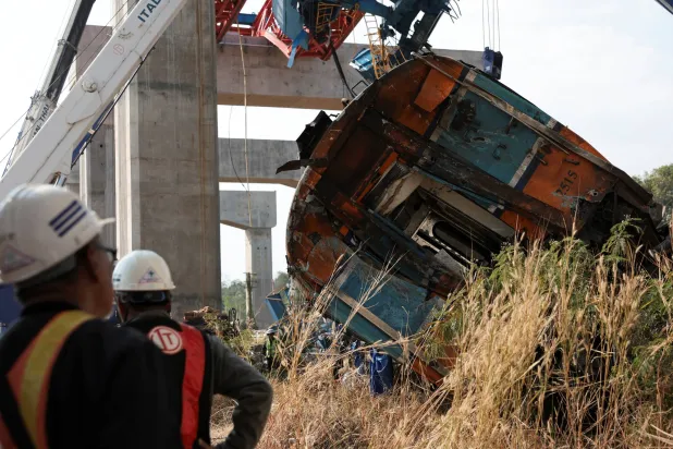 Wreckage at the site where a train was derailed when a construction crane collapsed and fell onto its carriages, causing several casualties, in Sikhio district, Nakhon Ratchasima province, Thailand, January 14, 2026. (Reuters)