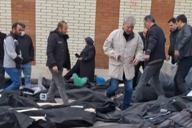 This video grab taken on January 14, 2026 from UGC images posted on social media on January 13, 2026, shows dozens of bodies lying on the ground at the Tehran Province Forensic Diagnostic and Laboratory Centre in Kahrizak, as grieving relatives search for their loved ones. (UGC / AFP) 