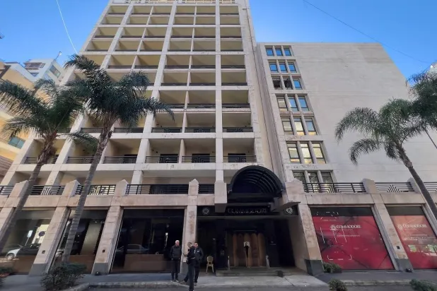 People stand outside the closed Commodore hotel, in Beirut, Lebanon, Sunday, Jan. 11, 2026. (AP)