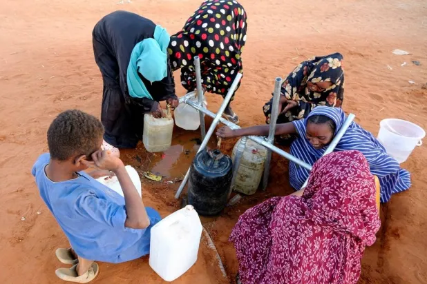 Displaced women fill water at displaced persons camp in El Obeid, North Kordofan State, Sudan, January 12, 2026. (Reuters) 