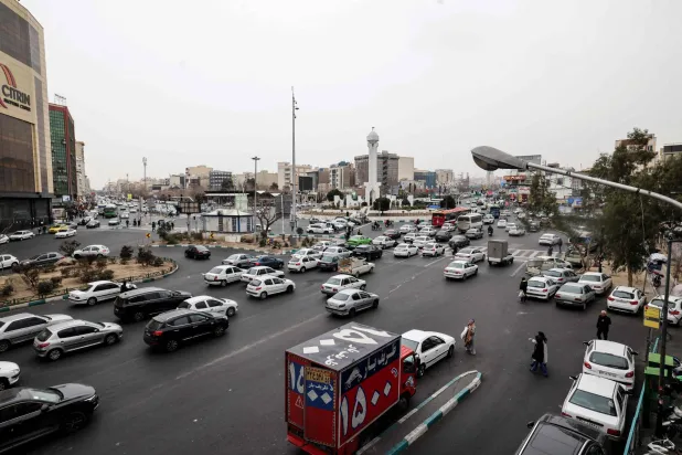 سيارات تعبر على طول أحد شوارع طهران 15 يناير الحالي (أ.ف.ب)
