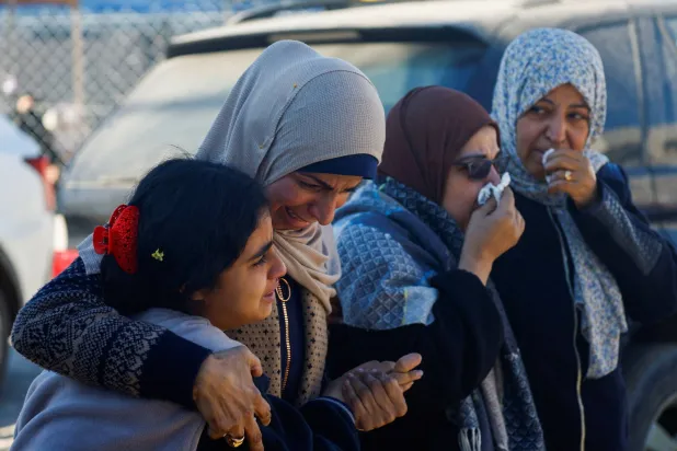 فلسطينيات يبكين قتلى سقطوا بغارة إسرائيلية في دير البلح بوسط قطاع غزة الجمعة (أ.ب)