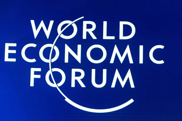 FILED - 23 January 2020, Switzerland, Davos: The World Economic Forum logo is displayed on a board during a plenary session. Photo: Ciaran McCrickard/World Economic Forum/dpa 