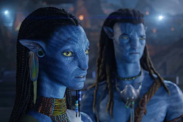 This image released by 20th Century Studios shows Neytiri, performed by Zoe Saldaña, left, and Jake Sully, performed by Sam Worthington, in a scene from "Avatar: Fire and Ash." (20th Century Studios via AP)
