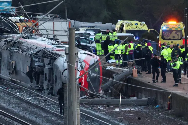 Members of the Spanish Civil Guard, along with other emergency personnel, work next to one of the trains involved in the accident, at the site of a deadly derailment of two high-speed trains near Adamuz, in Cordoba, Spain, January 19, 2026. (Reuters)