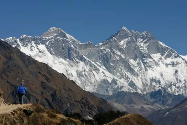 A tourist looks at a view of Mt. Everest from the hills of Syangboche in Nepal December 3, 2009. REUTERS/Gopal Chitrakar