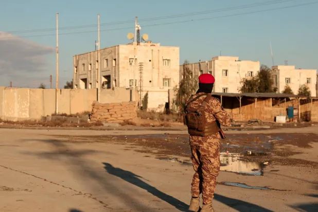  A member of Syrian military police stands guard near Raqqa prison, after the army took control of the city of Raqqa, Syria January 19, 2026. (Reuters)