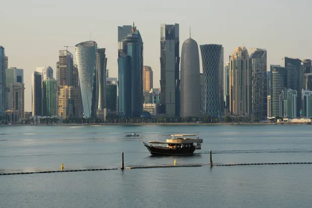 A boat makes its way past the Doha skyline in Doha, Qatar on Sunday, Jan. 18, 2026. (Sean Kilpatrick/The Canadian Press via AP)