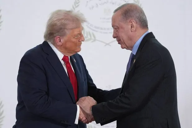 US President Donald Trump, left, greets Turkish President Recep Tayyip Erdogan during a summit on Gaza in Sharm el-Sheikh on October 13, 2025. (AFP)