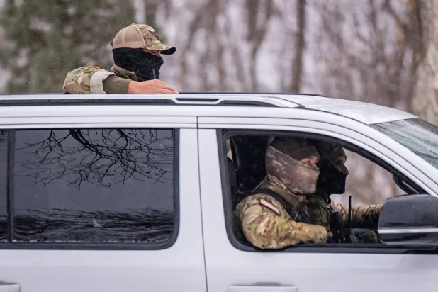 Federal agents patrol a street, Wednesday, Jan. 21, 2026, in Minneapolis. (AP Photo/Angelina Katsanis)