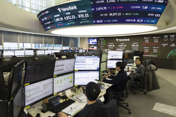 Traders work in front of screens at Hana Bank in Seoul (EPA)