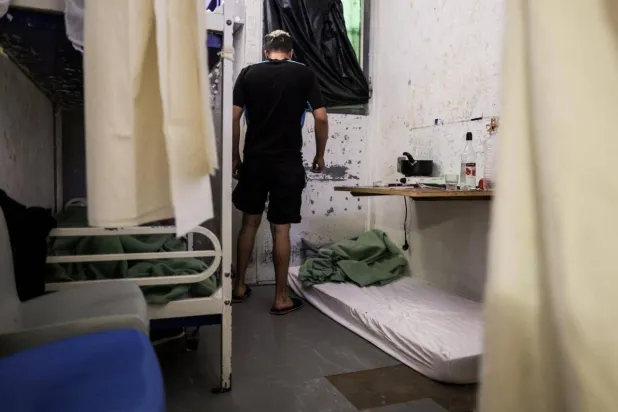 An inmate stands in his two-person cell near a mattress set for a third inmate at Gradignan prison, near Bordeaux, southwestern France, on October 3, 2022. Thibaud Moritz, AFP
