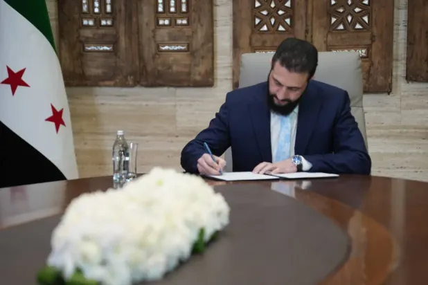 Suriye Cumhurbaşkanı Ahmed eş-Şera pazar akşamı SDG ile ateşkes anlaşmasının imzalanması sırasında (EPA)