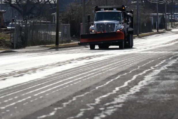A Nashville Department of Transportation truck applies salt brine to a roadway Thursday, Jan. 22, 2026, in Nashville, Tenn. ahead of a winter storm expected to hit the state over the weekend. (AP Photo/George Walker IV)