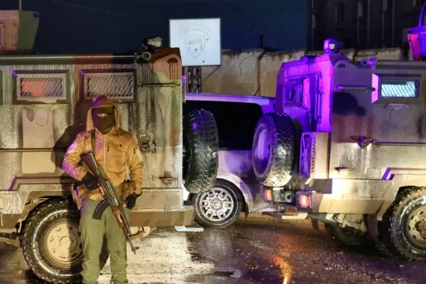 جنود الجيش السوري يحرسون سجن الأقطان بينما تنسحب «قوات سوريا الديمقراطية» منه (أ.ف.ب)