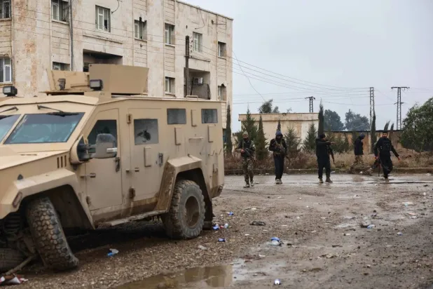 Syrian government forces inspect al-Aqtan prison in Raqqa after the SDF withdrew from the facility on Friday, Jan. 23 (AP). 