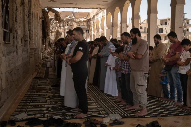 صلاة الجمعة في مدينة دير الزور الشرقية التي وصفها برنامج للأمم المتحدة بأنها المدينة الأكثر تضرراً في سوريا في 22 أغسطس 2025 (نيويورك تايمز)