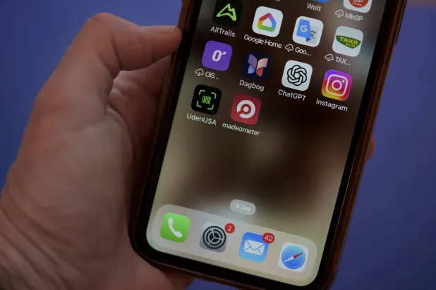 A close-up shows a mobile phone displaying the app UdenUSA, which translates to Without USA in Danish, Copenhagen, Denmark, 21 January 2026. EPA/Liselotte Sabroe  DENMARK OUT