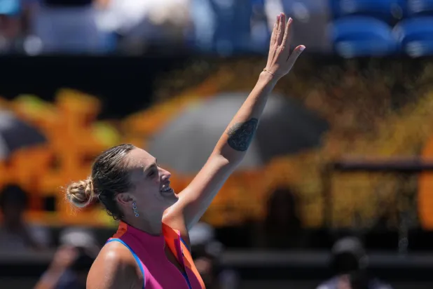 Aryna Sabalenka of Belarus waves after defeating Iva Jovic of the US in their quarter-final match at the Australian Open tennis championship in Melbourne, Australia, Tuesday, Jan. 27, 2026. (AP)