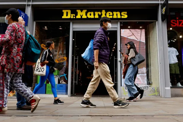 People walk past a Dr Martens store in Manchester, Britain, May 26, 2023. (Reuters)