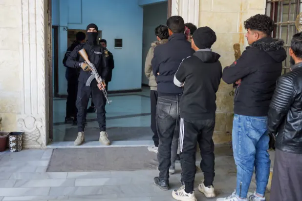 Members of the Kurdish-led Syrian Democratic Forces (SDF) queue to settle their status with Syrian government in Raqqa, Syria January 27, 2026. REUTERS/Karam al-Masri 