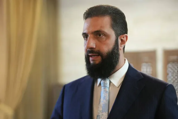 Syria's President Ahmed al-Sharaa speaks after signing an agreement at the Presidential Palace in Damascus on January 18, 2026. (AFP / Handout)