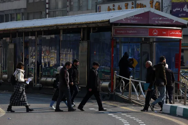 Iranians walk along a street in Tehran, Iran, 27 January 2026. (EPA)