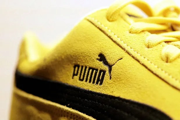 A Puma logo is seen on a Puma Speedcat OG sneaker displayed at the Puma Mostro House in Paris, France, January 24, 2025. (Reuters) 