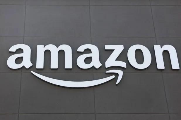 This photograph shows the Amazon logo displayed outside of an Amazon Fresh grocery store in Torrance, California on July 29, 2025. (AFP)