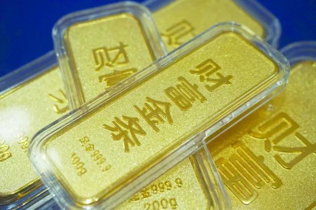 Gold bars with Chinese characters reading “Fortune Gold” are seen at a gold shop in Hangzhou, in China’s eastern Zhejiang province on January 26, 2026.  (Photo by AFP) / China OUT