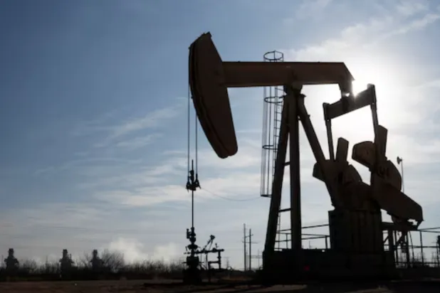 A pump jack operates near a gas turbine power plant in the Permian Basin oil field outside of Odessa, Texas, US February 18, 2025. REUTERS/Eli Hartman 