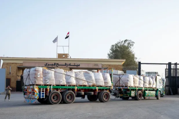 A truck enters the Egyptian gate of the Rafah crossing, heading for inspection by Israeli authorities before entering the Gaza Strip, Tuesday, Jan. 27, 2026. (AP Photo/Mohamed Arafat)

