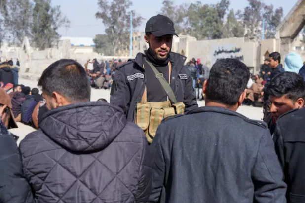 Members of the Kurdish-led Syrian Democratic Forces (SDF) queue to settle their status with Syrian government in Raqqa, Syria January 27, 2026. REUTERS/Karam al-Masri 