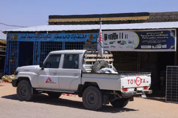 A pickup truck of the Medecins Sans Frontieres (MSF), stands in front of a market stall for solar energy equipment, in the city of Tine, eastern Chad, November 25, 2025. REUTERS/Amr Abdallah Dalsh